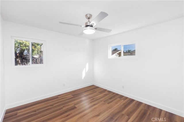 empty room featuring ceiling fan and dark hardwood / wood-style flooring