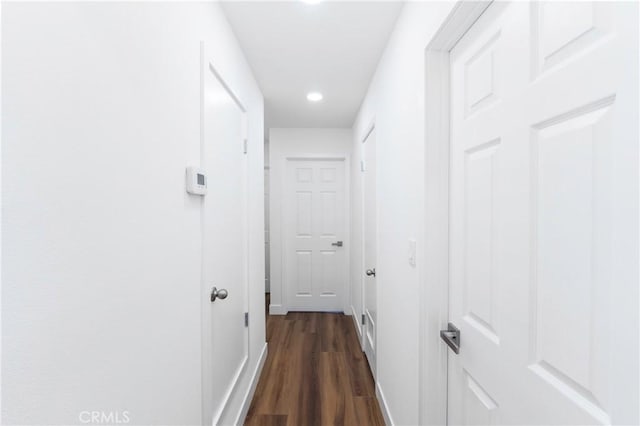 corridor with dark hardwood / wood-style flooring