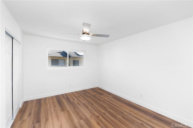 empty room with ceiling fan and hardwood / wood-style flooring