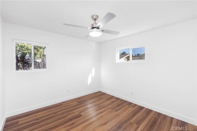 spare room featuring ceiling fan and dark hardwood / wood-style flooring