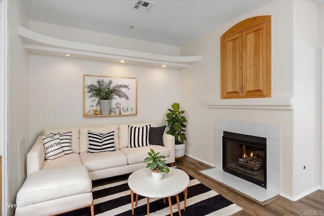 living room featuring hardwood / wood-style flooring and a fireplace