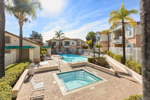 view of pool with a patio area and a community hot tub