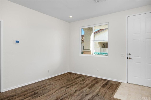 foyer with baseboards, wood finished floors, and recessed lighting