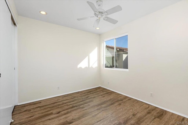 empty room featuring a ceiling fan, baseboards, dark wood-style flooring, and recessed lighting