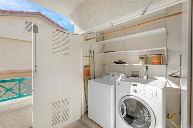 clothes washing area featuring washing machine and dryer