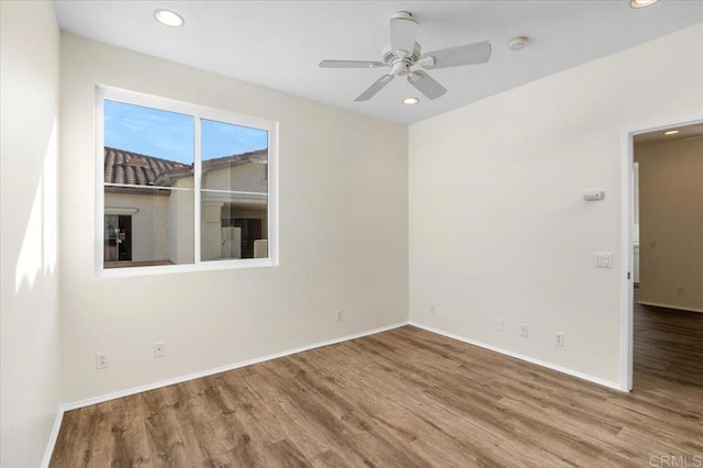 unfurnished room featuring recessed lighting, baseboards, and wood finished floors