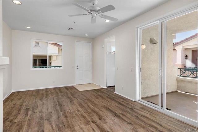 interior space with baseboards, visible vents, a ceiling fan, dark wood-style flooring, and recessed lighting