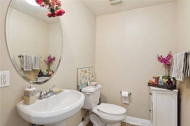 bathroom with toilet and sink