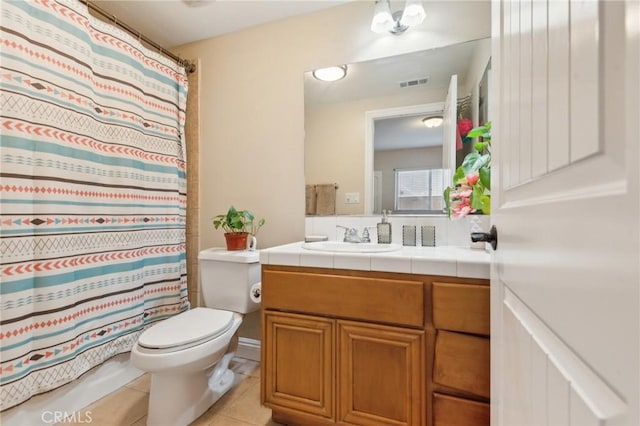 bathroom with toilet, tile patterned floors, walk in shower, and vanity