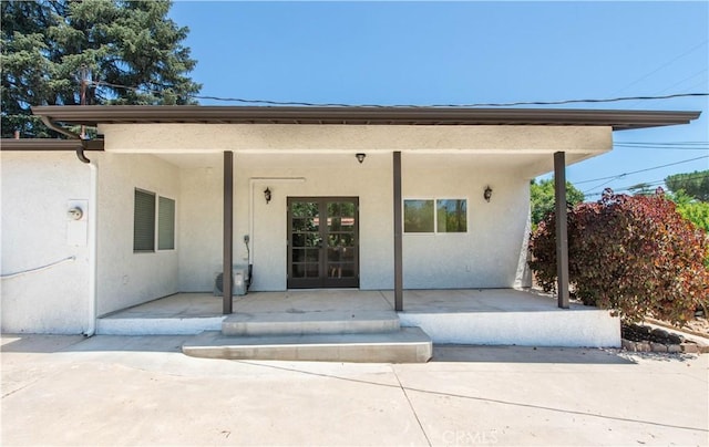 doorway to property featuring covered porch