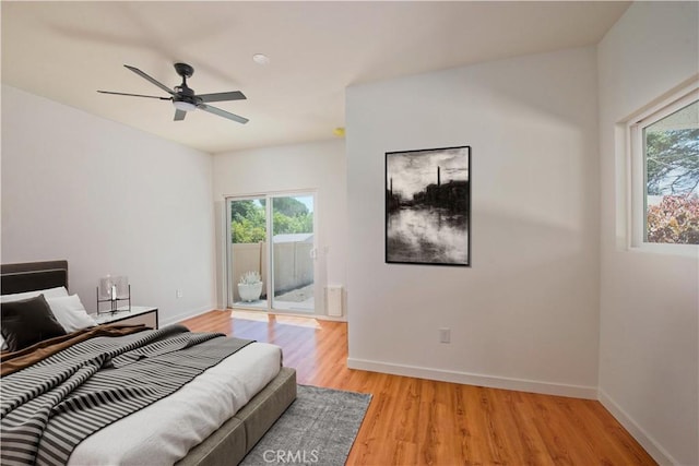 bedroom with ceiling fan, access to exterior, and light wood-type flooring