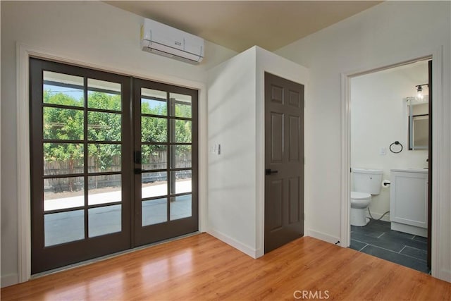 doorway featuring a wealth of natural light, a wall mounted AC, french doors, and hardwood / wood-style flooring