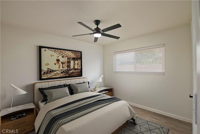 bedroom with ceiling fan and wood-type flooring