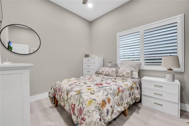 bedroom with ceiling fan and light wood-type flooring