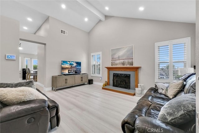 living room featuring high vaulted ceiling, beam ceiling, and light wood-type flooring