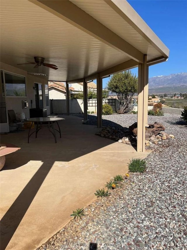 view of patio / terrace featuring ceiling fan and a mountain view