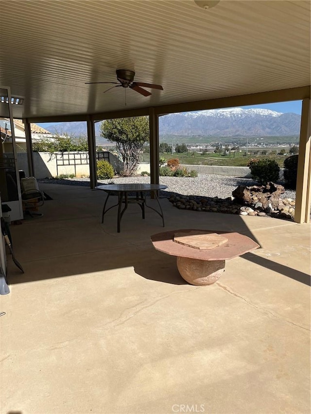 view of patio / terrace featuring a mountain view and ceiling fan