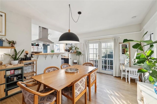 dining room with light hardwood / wood-style flooring and french doors