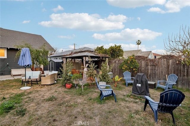 view of yard with an outdoor living space and a gazebo