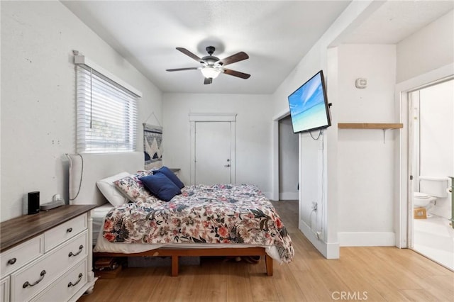 bedroom featuring ceiling fan, light hardwood / wood-style flooring, and ensuite bath