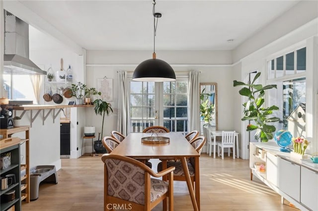 dining room with french doors and light wood-type flooring