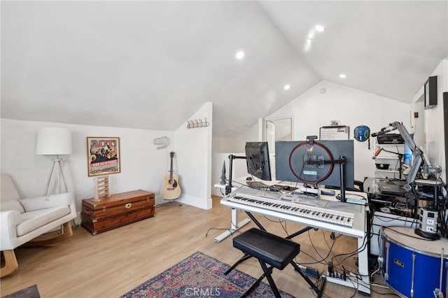 misc room featuring light wood-type flooring and vaulted ceiling