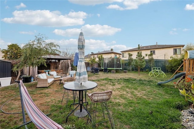 view of yard featuring a playground, a trampoline, a gazebo, and outdoor lounge area