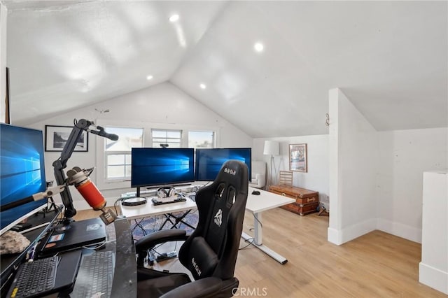 office with lofted ceiling and light hardwood / wood-style flooring