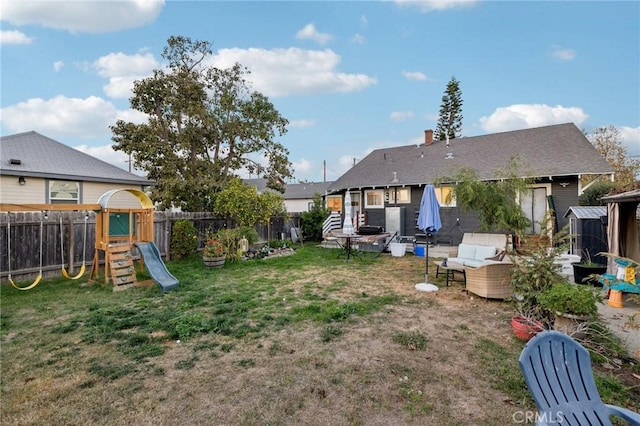 view of yard with an outdoor hangout area and a playground