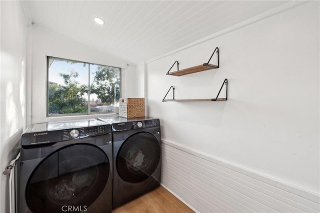 laundry room with light wood-type flooring and washing machine and dryer