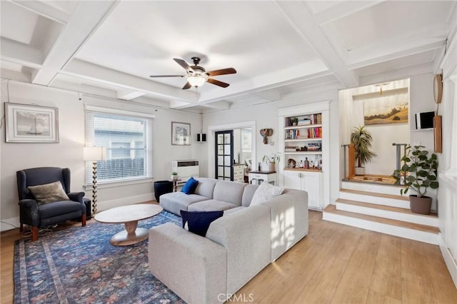 living room featuring beam ceiling, light wood-type flooring, coffered ceiling, and ceiling fan