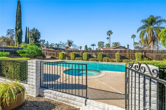 view of pool with a fenced in pool, a patio area, a fenced backyard, and an in ground hot tub