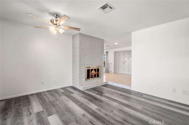 unfurnished living room featuring ceiling fan, a fireplace, and hardwood / wood-style floors