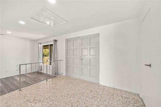 unfurnished room featuring baseboards and recessed lighting