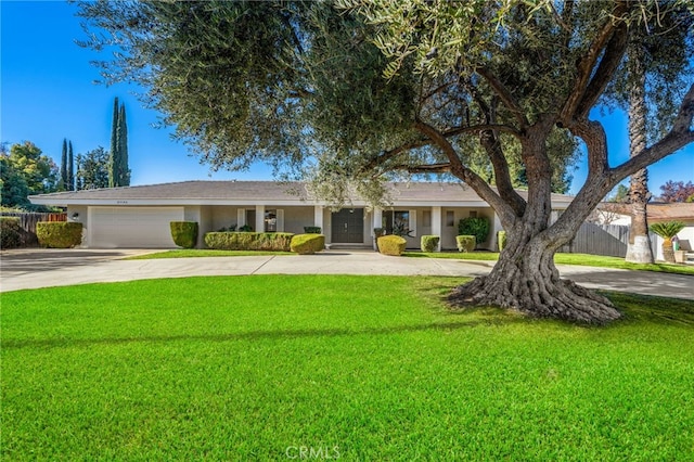 ranch-style house with a garage and a front lawn