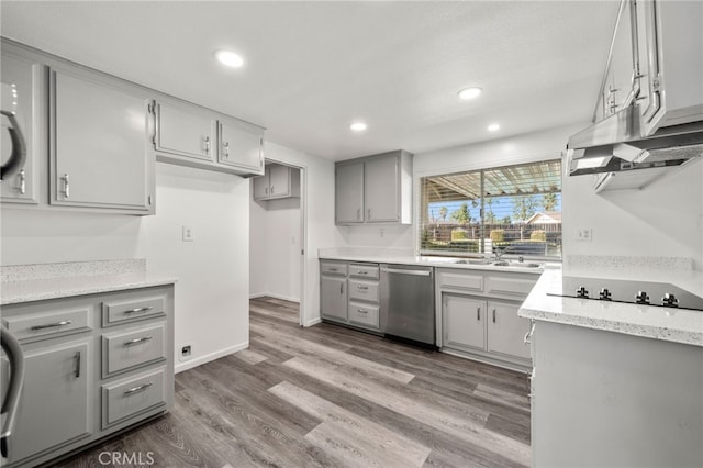 kitchen featuring wood finished floors, stainless steel dishwasher, gray cabinets, and black electric cooktop