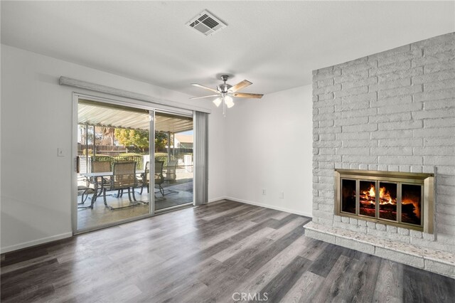 unfurnished living room with ceiling fan, a fireplace, and dark hardwood / wood-style floors