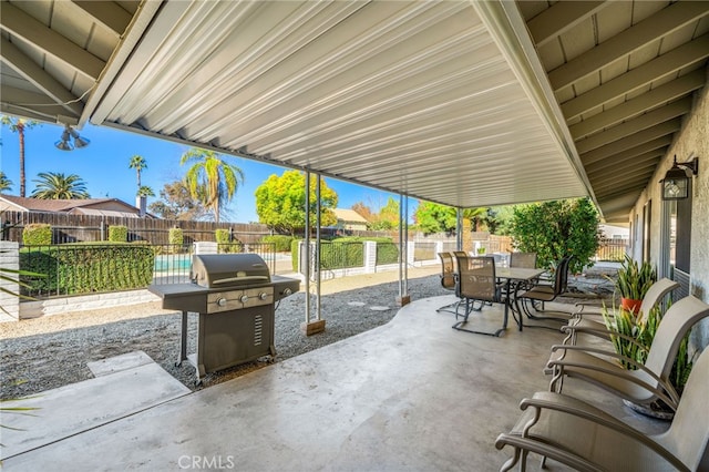 view of patio with a fenced backyard, grilling area, and outdoor dining space