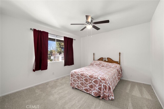 bedroom with ceiling fan and light colored carpet