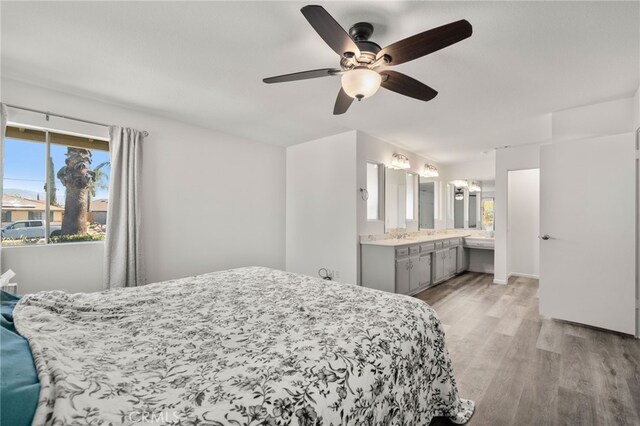 bedroom featuring ceiling fan, light hardwood / wood-style floors, and ensuite bathroom