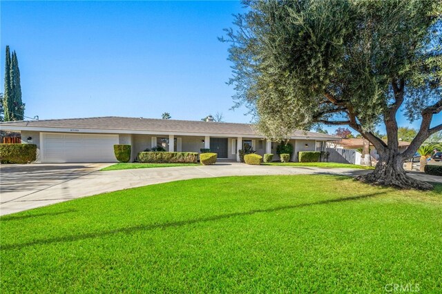 single story home featuring a front yard and a garage