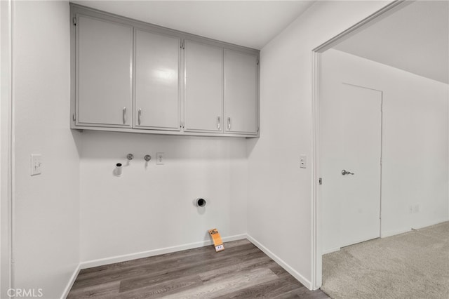 laundry room with cabinet space, baseboards, and dark wood-type flooring