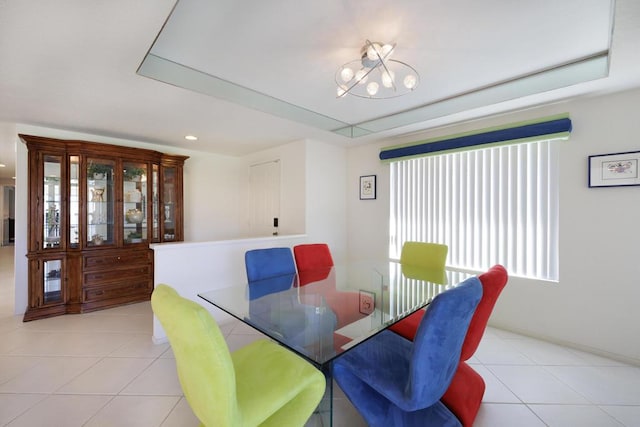 dining space featuring light tile patterned floors and a notable chandelier