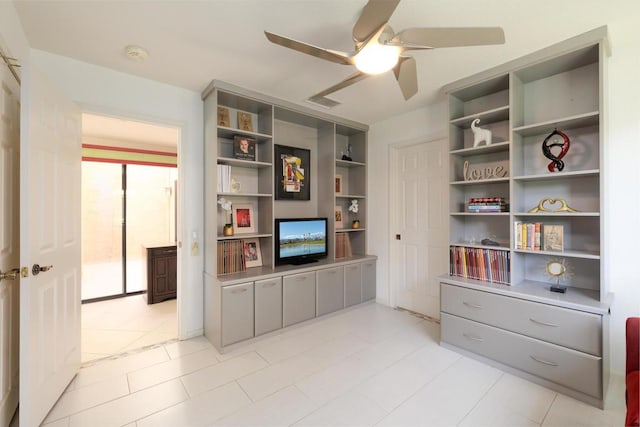 interior space with ceiling fan and light tile patterned flooring