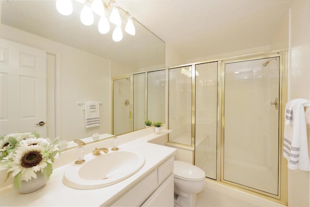 bathroom with vanity, toilet, tile patterned flooring, and a shower with door