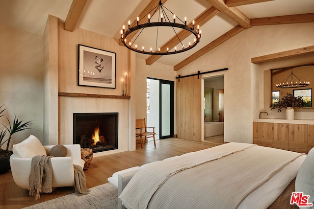 bedroom featuring high vaulted ceiling, beamed ceiling, light hardwood / wood-style flooring, and a barn door