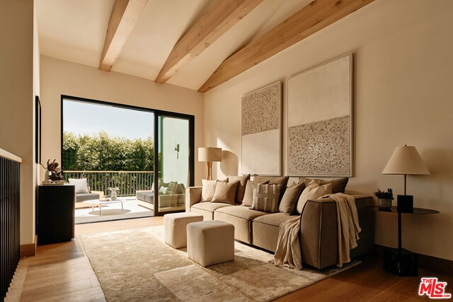 interior space with beam ceiling and light hardwood / wood-style flooring