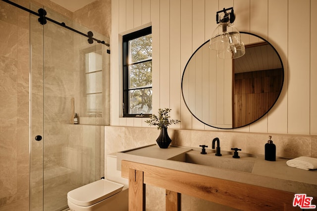 bathroom with toilet, a shower with shower door, and vanity