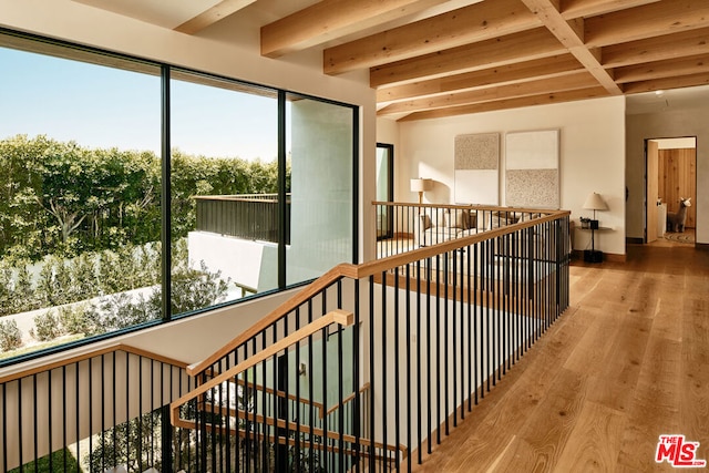 interior space with beam ceiling and hardwood / wood-style floors