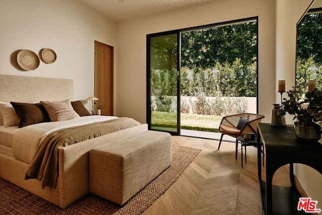 bedroom featuring light parquet flooring and access to outside